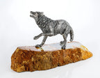 Handcrafted sterling silver wolf sculpture on natural onyx base