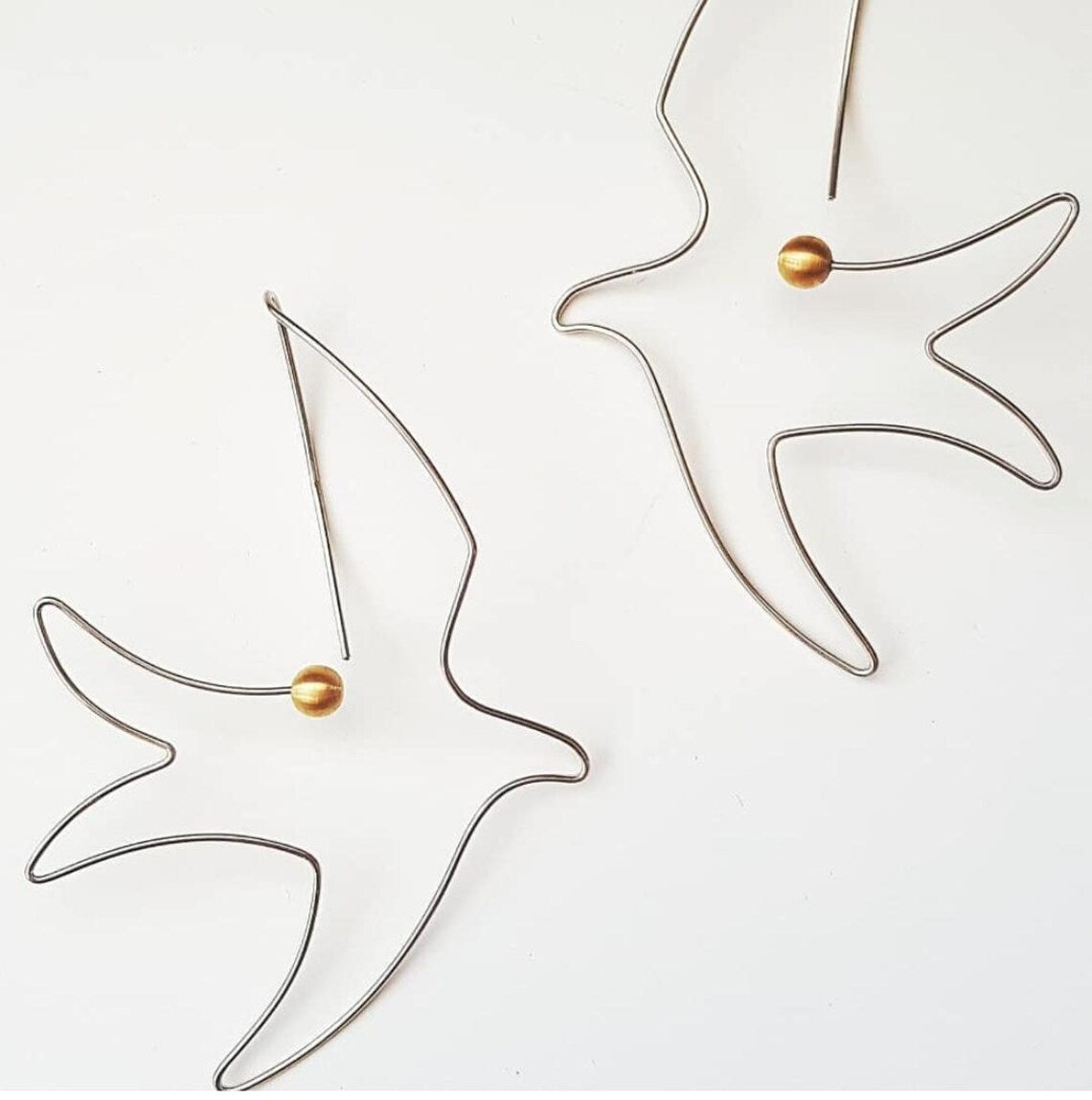 Handcrafted sterling silver bird earrings with pearl accents