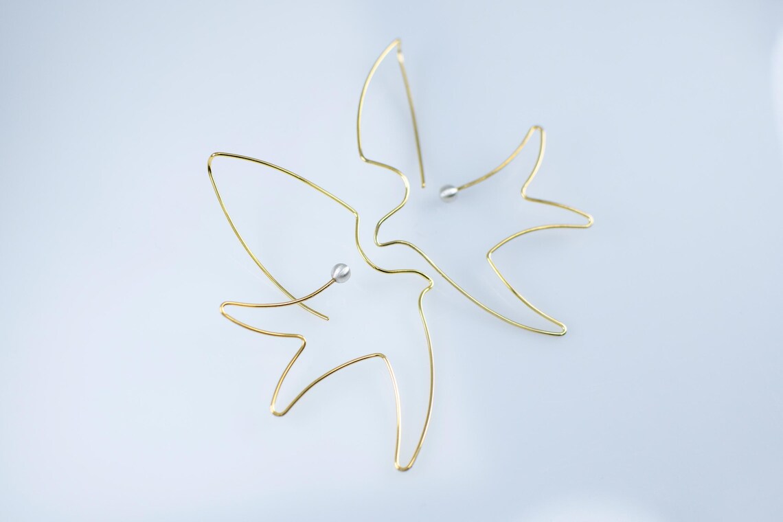 Pearl accent bird earrings in sterling silver