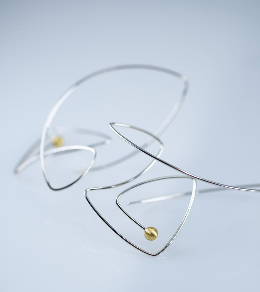 Minimalist fish-shaped dangle earrings made from sterling silver