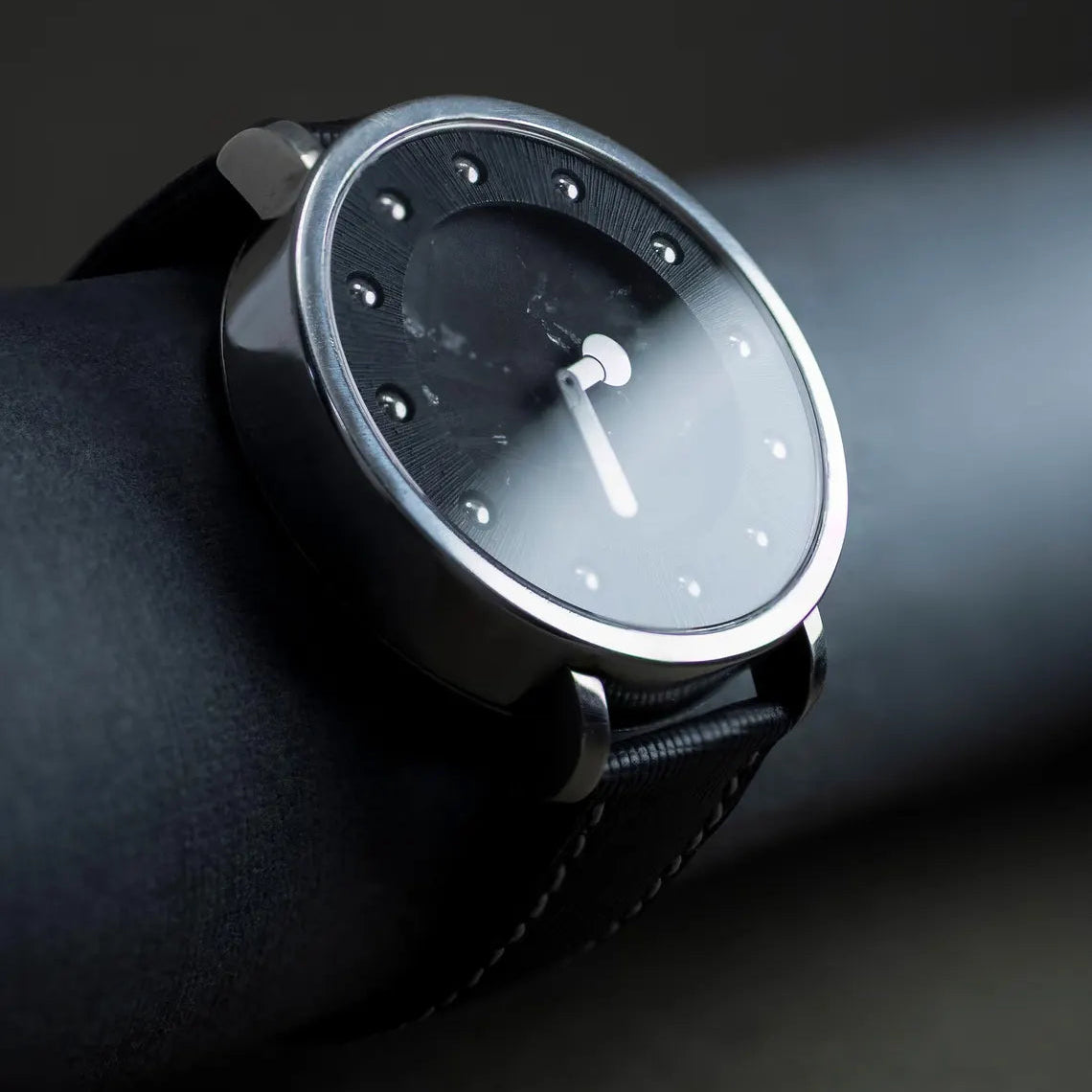 Wristwatch with a minimalist design on a dark background