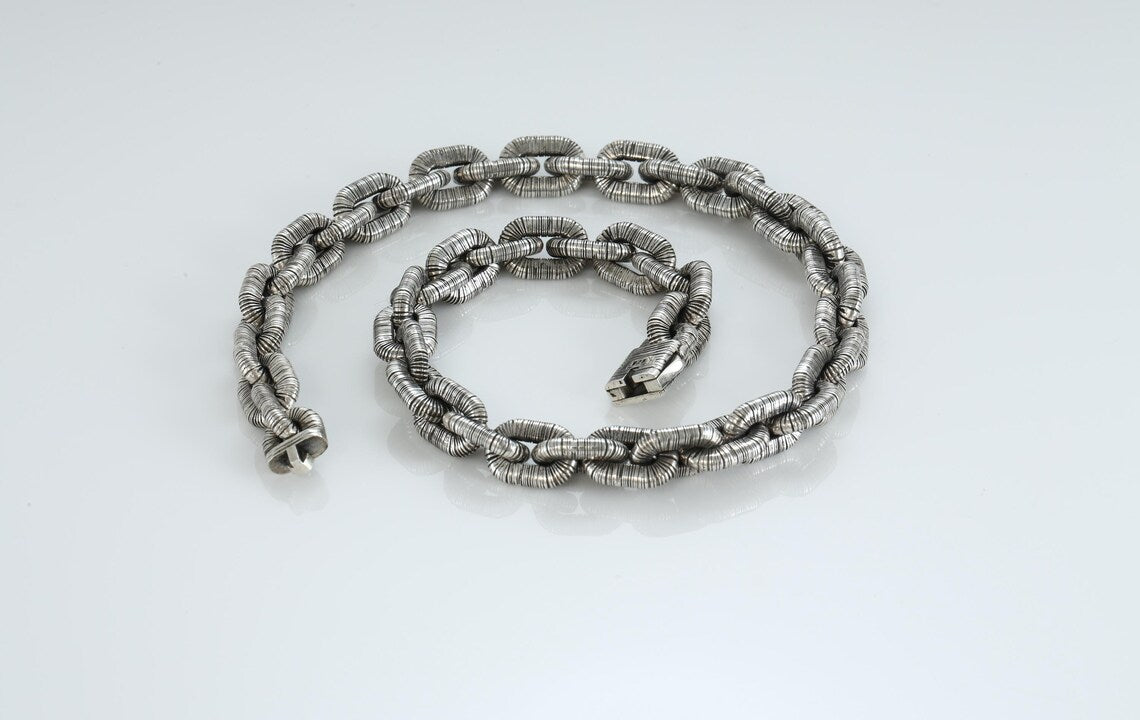 Bold silver chain necklace with anchor pendant close-up