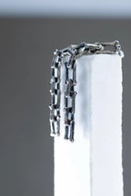 Modern oxidized silver earrings with chain motif
