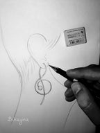 Hand drawing a treble clef symbol on paper with a pen.