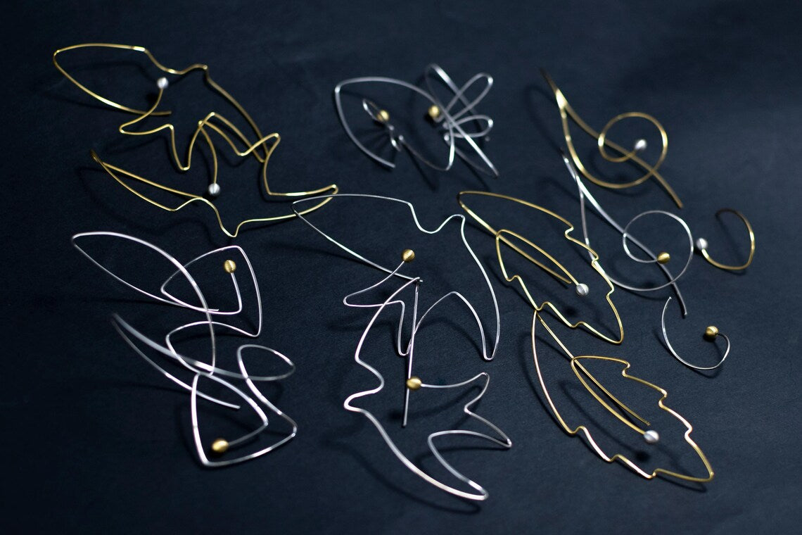 Fish shaped silver earrings with pearl accents
