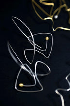 Abstract wire sculpture on a black background