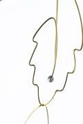 Minimalist botanical wire earrings featuring elegant pearl details