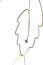Minimalist botanical wire earrings featuring elegant pearl details