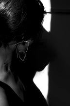 Black and white silhouette of a person with sunglasses against a light background