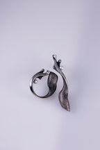 Pair of silver earrings on a light gray background