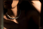 Textured silver chain and anchor pendant detail