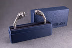 Silver ring with snake design in a blue box on a gray background