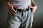 Handcrafted sterling silver hand-shaped belt buckle on black suede strap