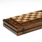 Hand-carved chess pieces on the grapevine board