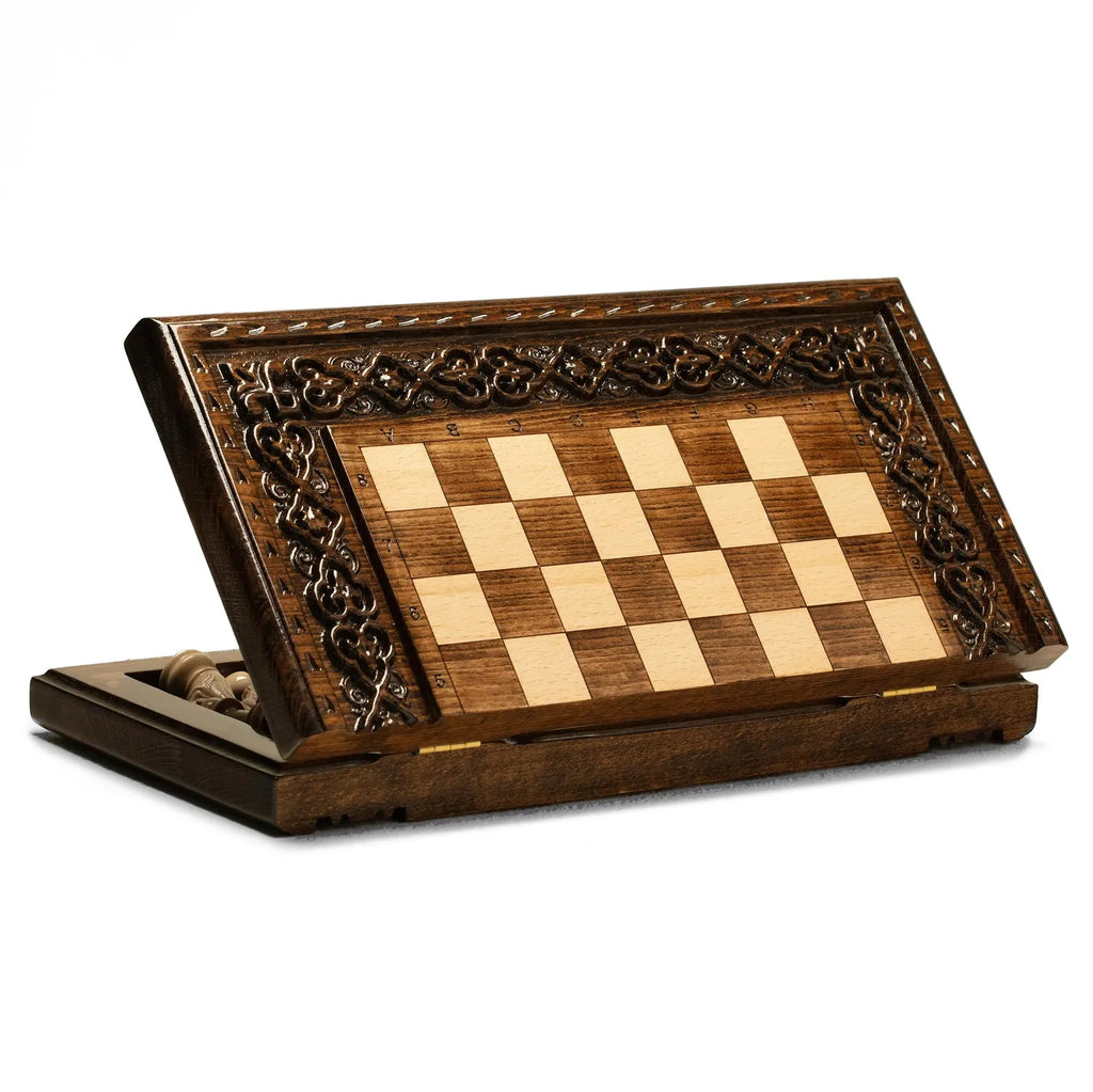 Carved wooden chess pieces in starting position