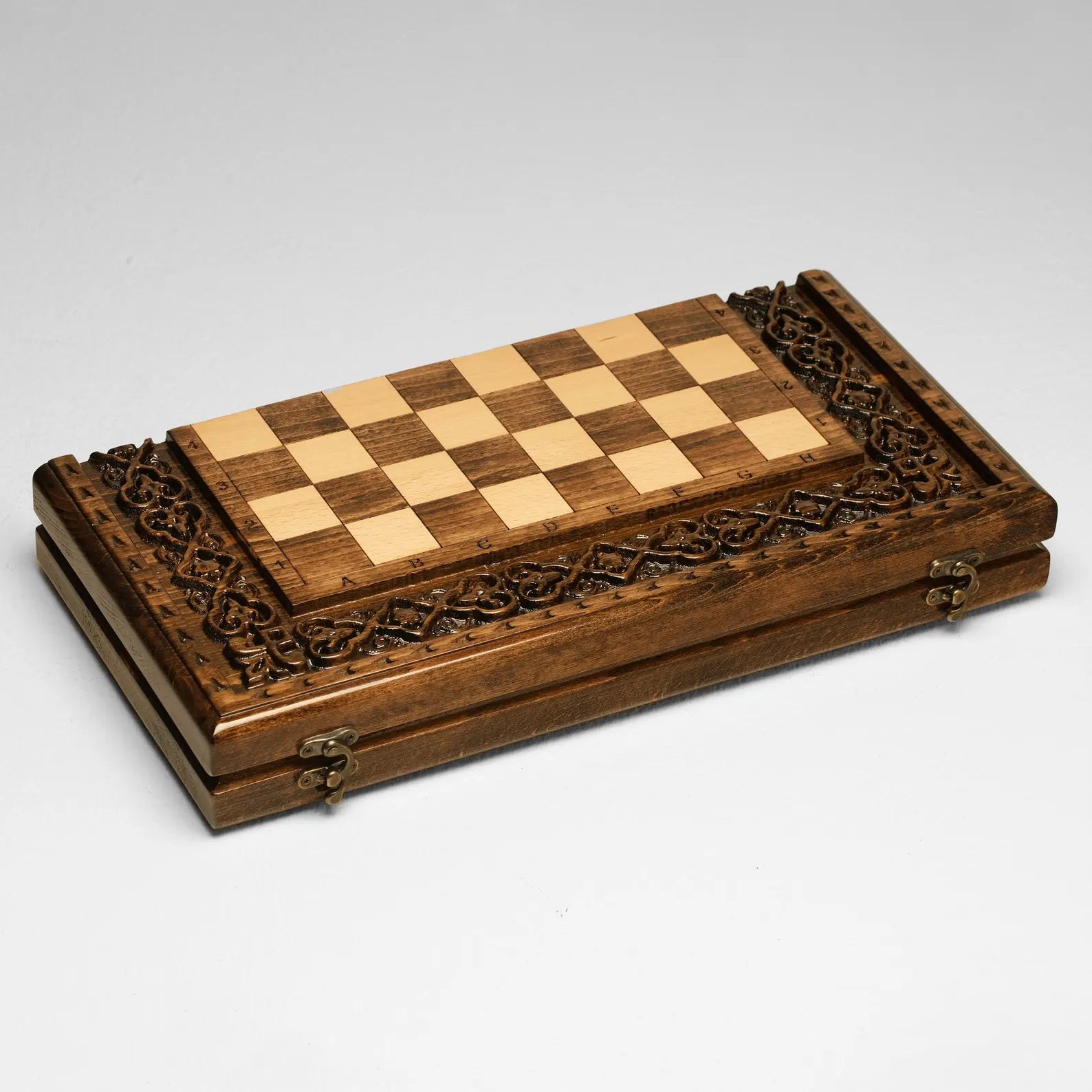 Wooden chess set folded, showing the carved cover