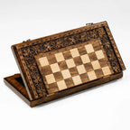 Grapevine-carved wooden chess set displayed open
