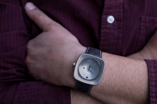 Luxury artisan silver watch with blue enamel hands