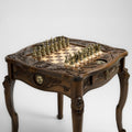 Regal chess table with carved lion design and brass pieces