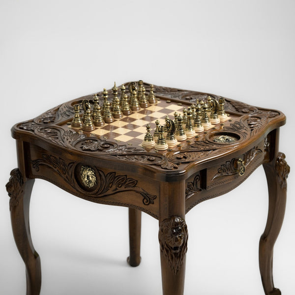 Regal chess table with carved lion design and brass pieces