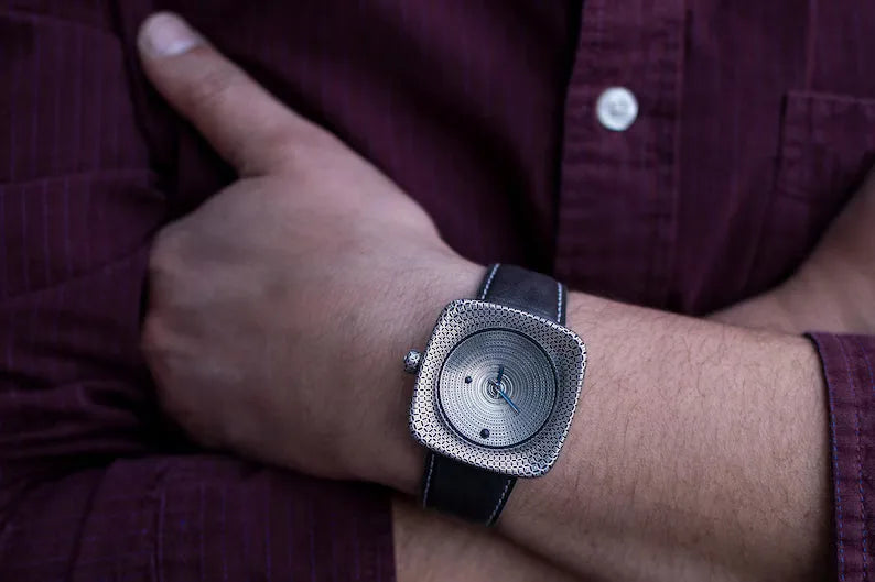 Luxury artisan silver watch with blue enamel hands